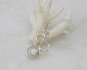 opal gemstone silver necklace on coral