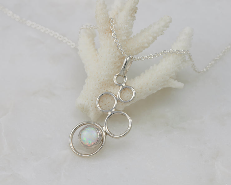opal gemstone silver necklace on coral