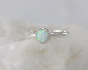 silver opal ring on white rock