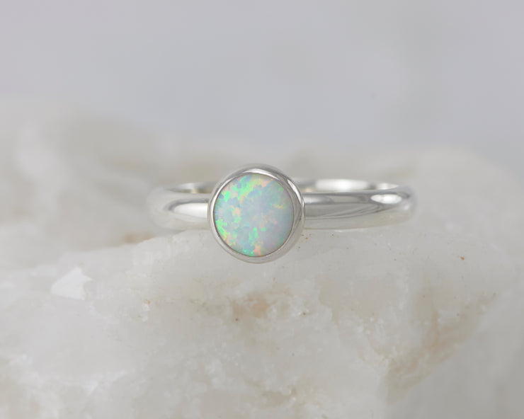 silver opal ring on white rock
