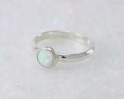 simple opal silver ring on white marble