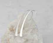 Hoop Dangle Earrings shown on a white rock