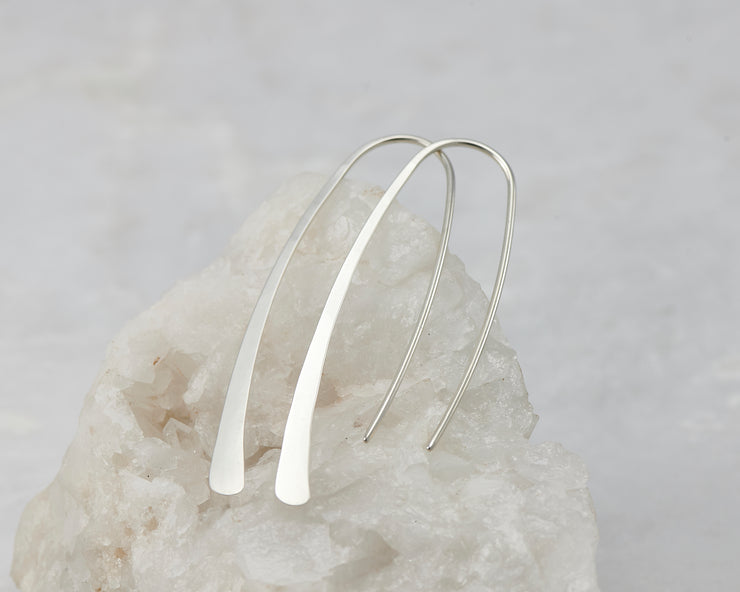 Hoop Dangle Earrings shown on a white rock