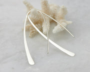 Sterling Silver hoop earrings hanging from coral