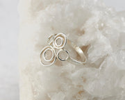Silver many circles ring on white rock
