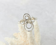 Silver many circles ring on coral