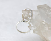 interlocking russian wedding rings on crystal rock