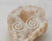 silver spiral earrings on quartz