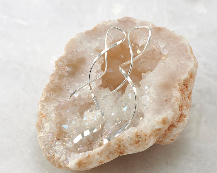 silver spiral threader earrings on quartz