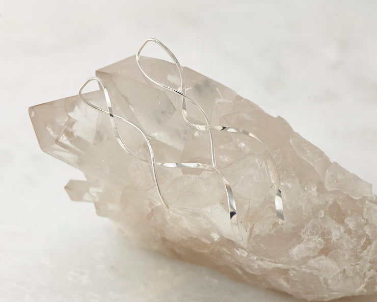 silver thread earrings on white crystal