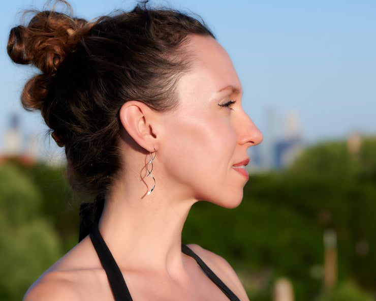 woman wearing silver spiral threader earrings