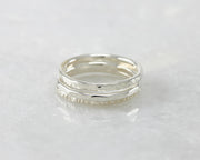 hammered stacking rings on white marble