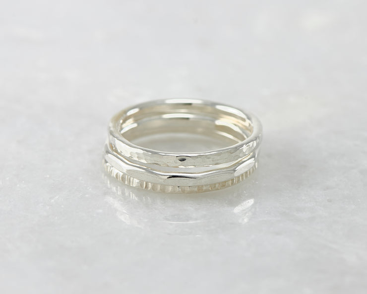 hammered stacking rings on white marble