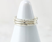 White rings holder with hammered Silver stacking rings