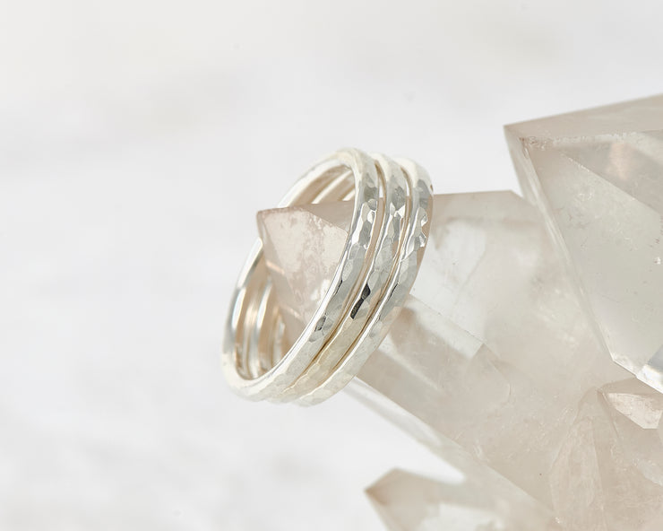 Silver hammered stacking rings on crystal rock