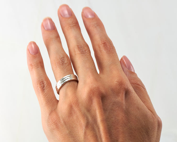 woman wearing silver stacking ring set