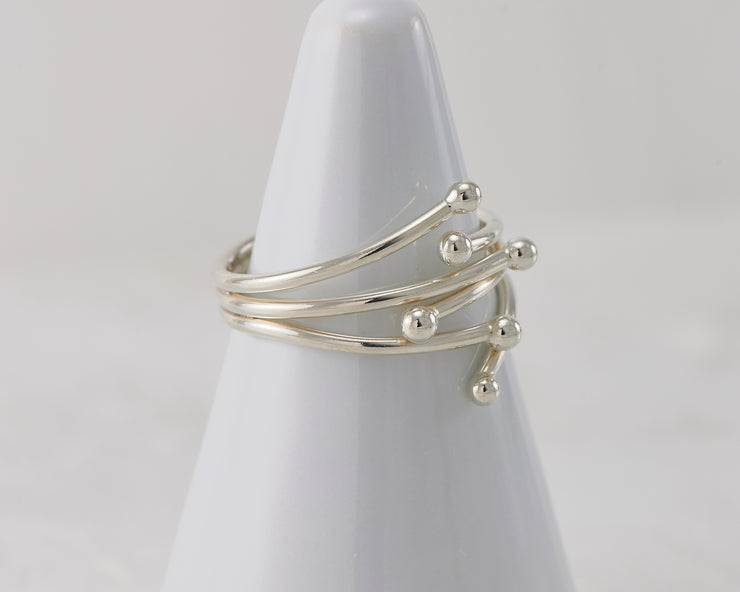 Silver statement wrap ring on white ring holder