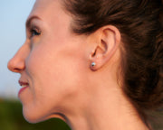 Woman wearing silver ball stud earrings