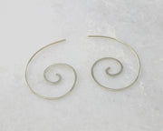 silver swirl threader earrings on white marble