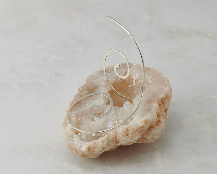 silver thread earrings on white crystal