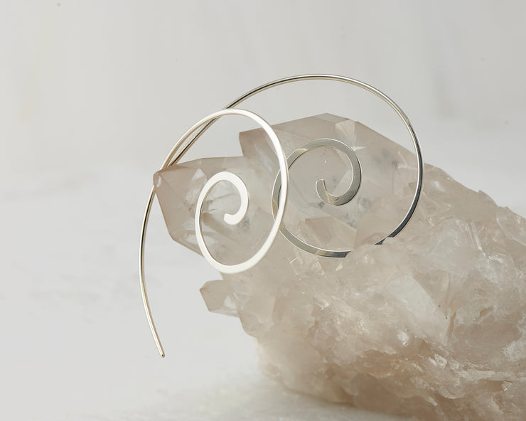 silver thread earrings on white crystal