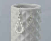 Silver teardrops earrings on geometric vase