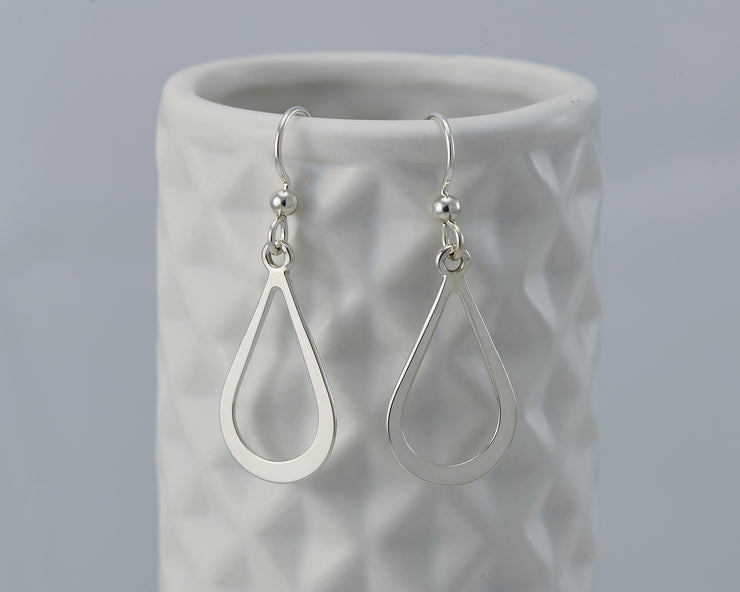Silver teardrops earrings on geometric vase