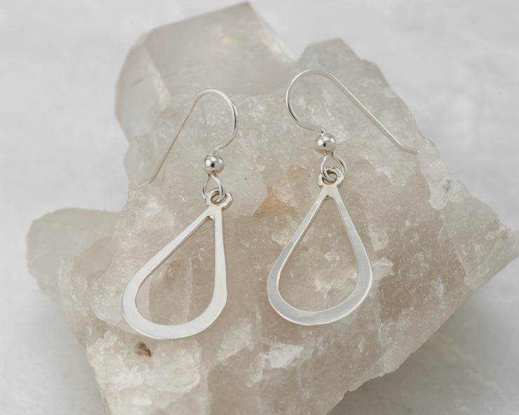 Silver teardrops earrings on crystal rock
