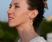 Woman wearing silver teardrops earrings