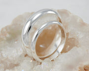 two silver wedding bands in crystal