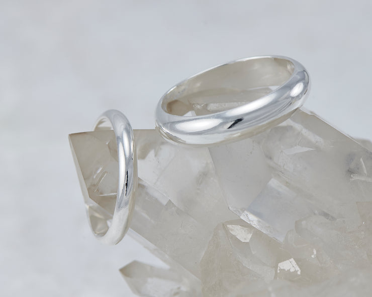 silver wedding band set on crystal