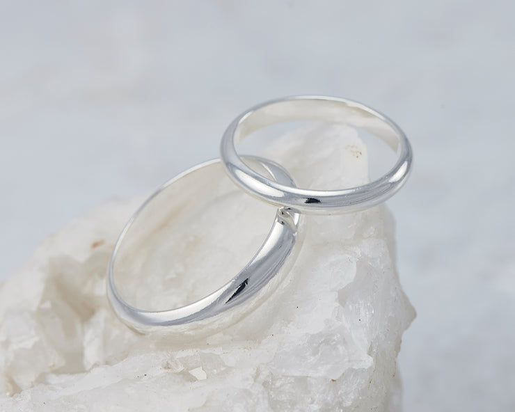 silver wedding ring set on white rock