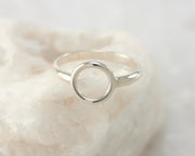 silver circle ring on white rock
