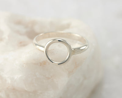 silver circle ring on white rock