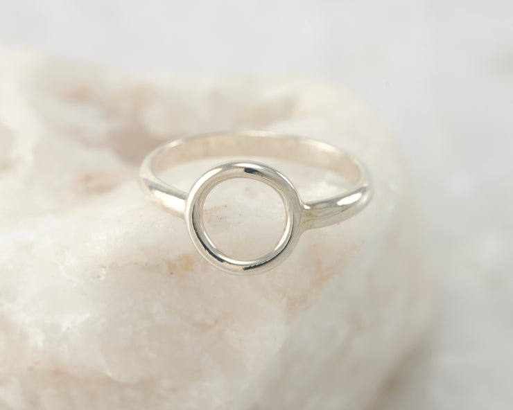 silver circle ring on white rock