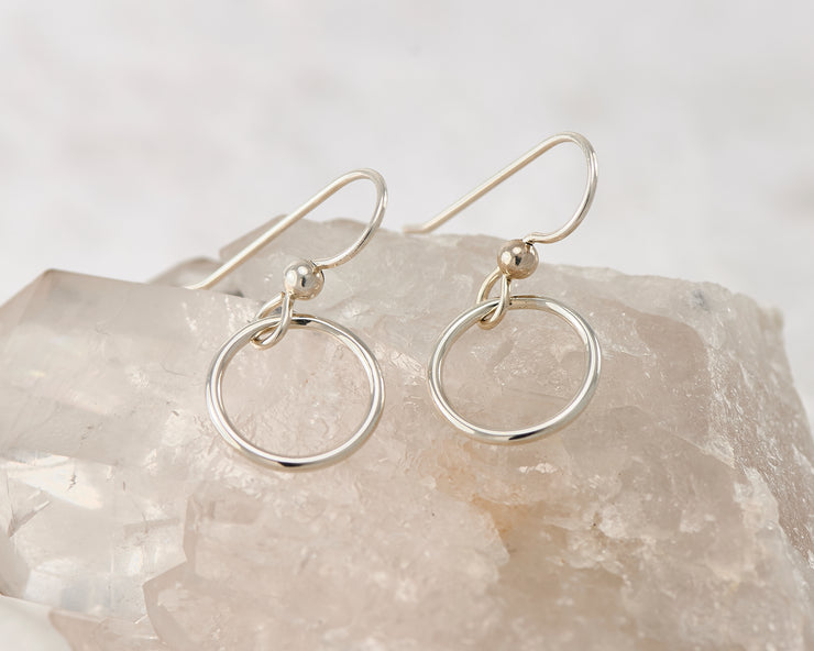 silver thread earrings on white crystal