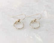 silver small hoop earrings on white marble