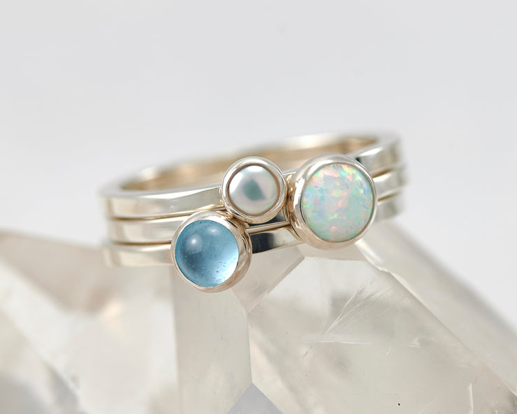 silver stacking rings opal, pearl, blue topaz ring on crystal rock