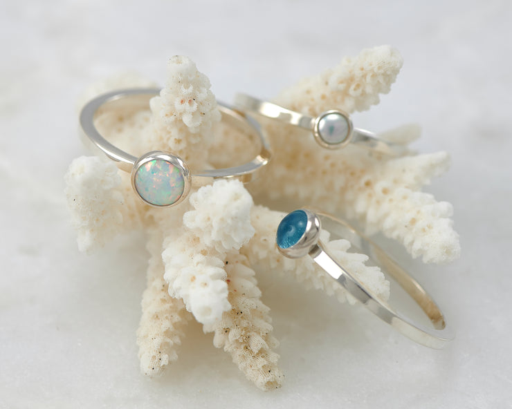 opal, pearl, blue topaz ring on coral