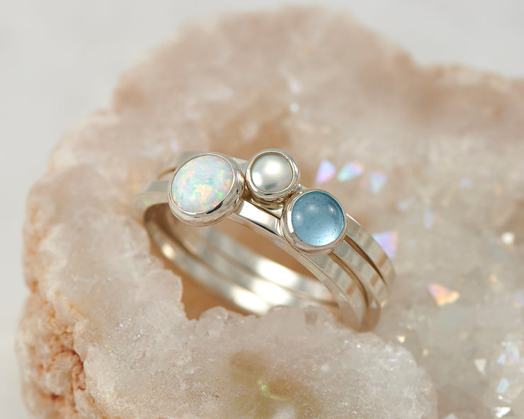 central opal, pearl, blue topaz ring in quartz