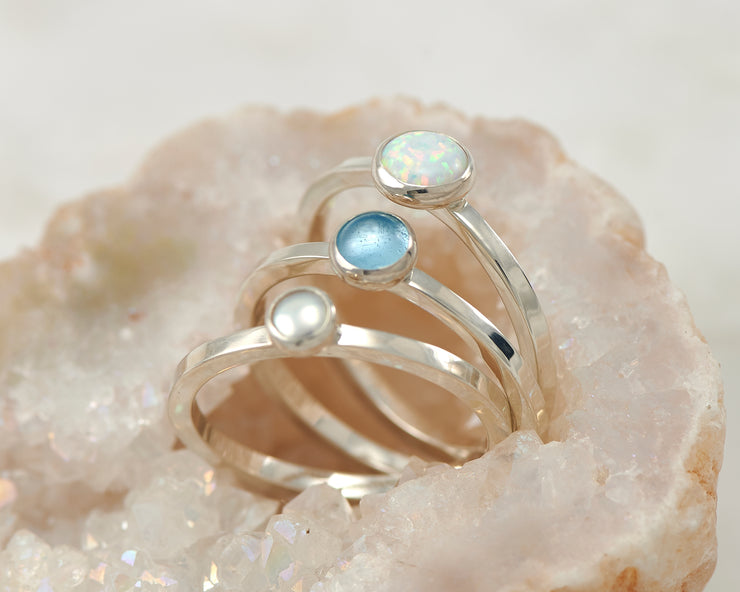 central opal, pearl, blue topaz ring in quartz
