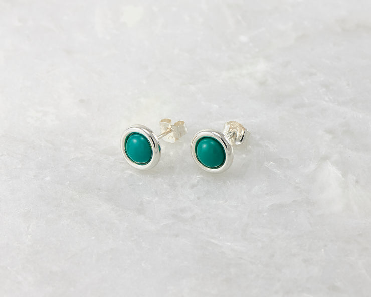 silver turquoise stud earrings on white marble