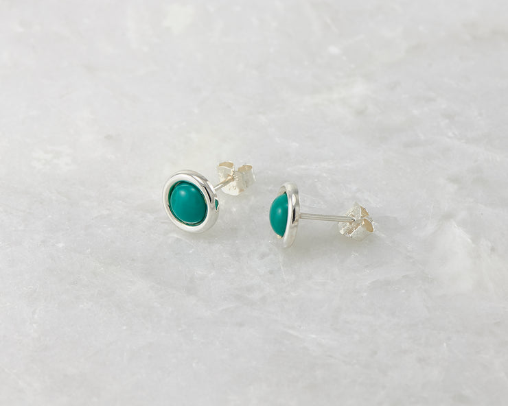 simple turquoise silver stud earrings on white marble
