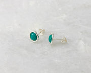 silver turquoise stud earrings on white marble