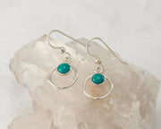 Silver turquoise hoop earrings on crystal rock