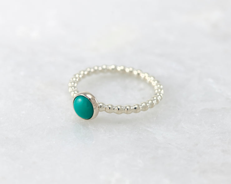 beaded turquoise ring on white marble