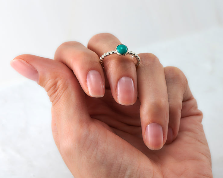 woman holding turquoise silver ring