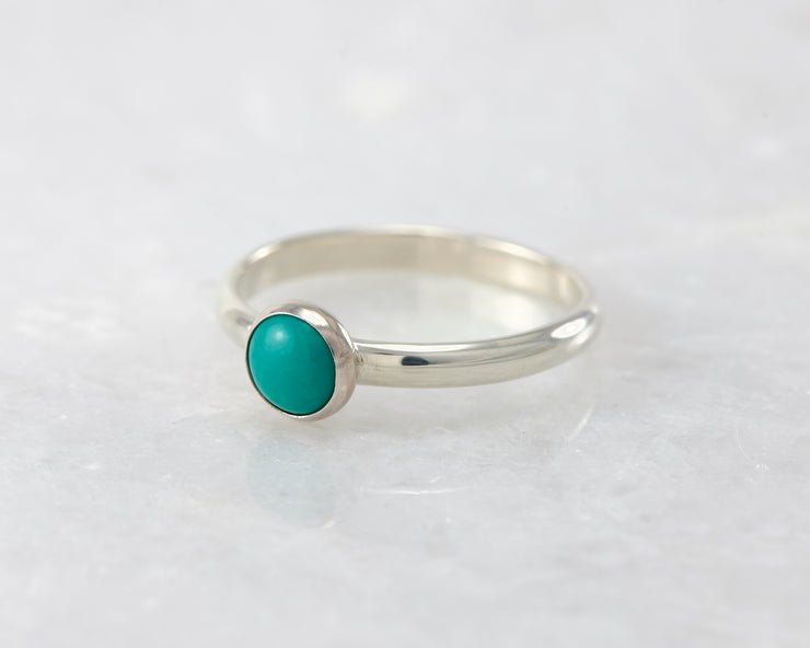 simple turquoise silver ring on white marble