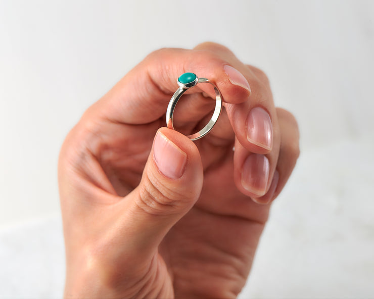 woman holding silver turquoise ring
