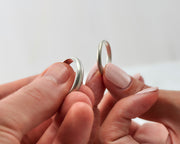 his and hers brushed wedding bands on man and woman's hands
